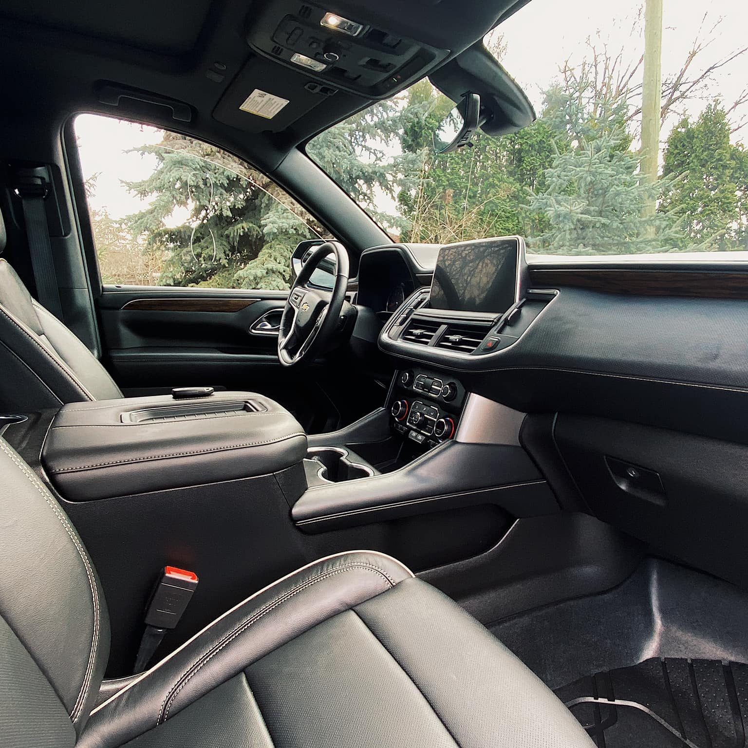 The black leather interior of a car after an interior detailing and fabric protection